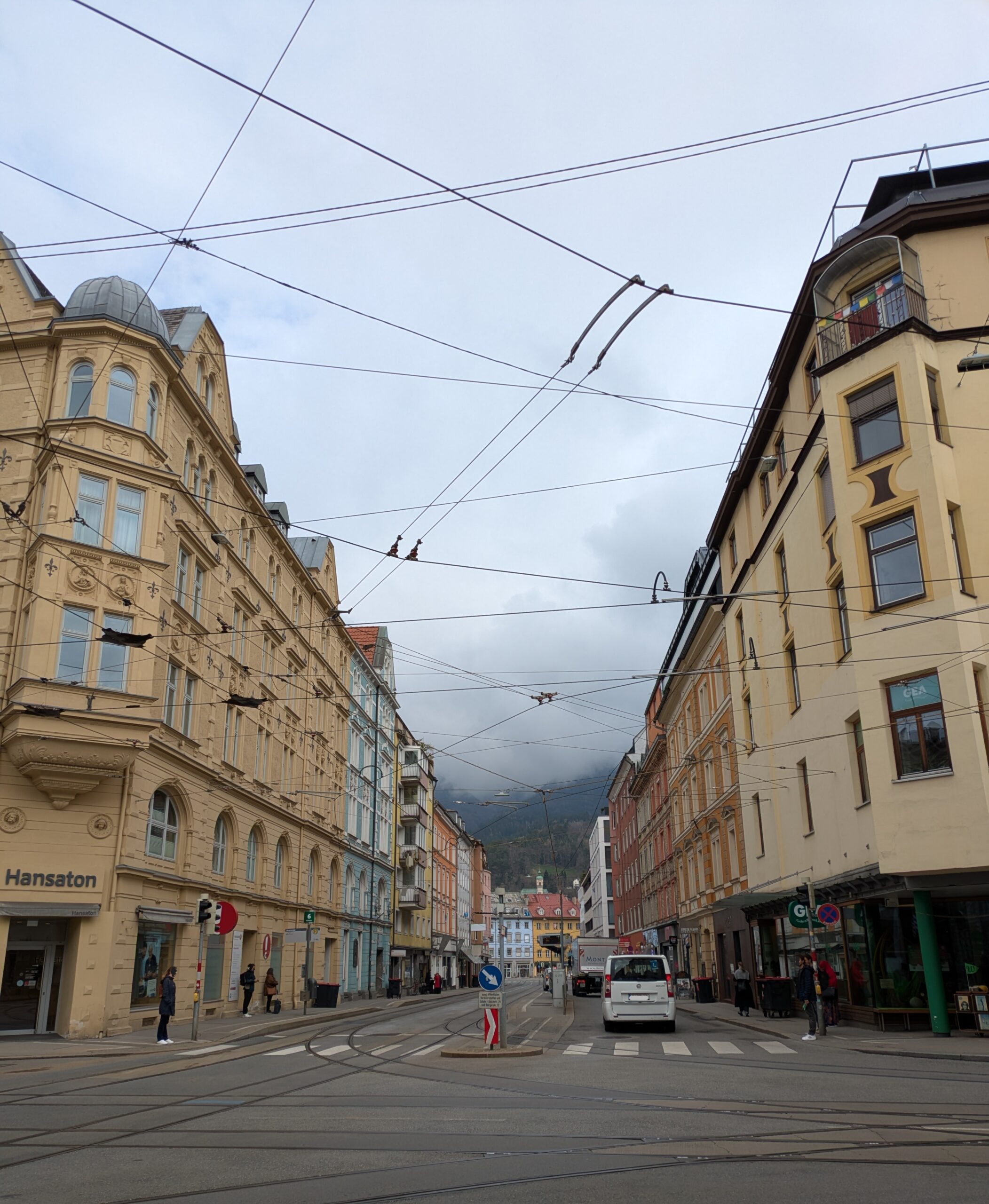Streetscape of Innsbruck with alps hiding under clouds in background